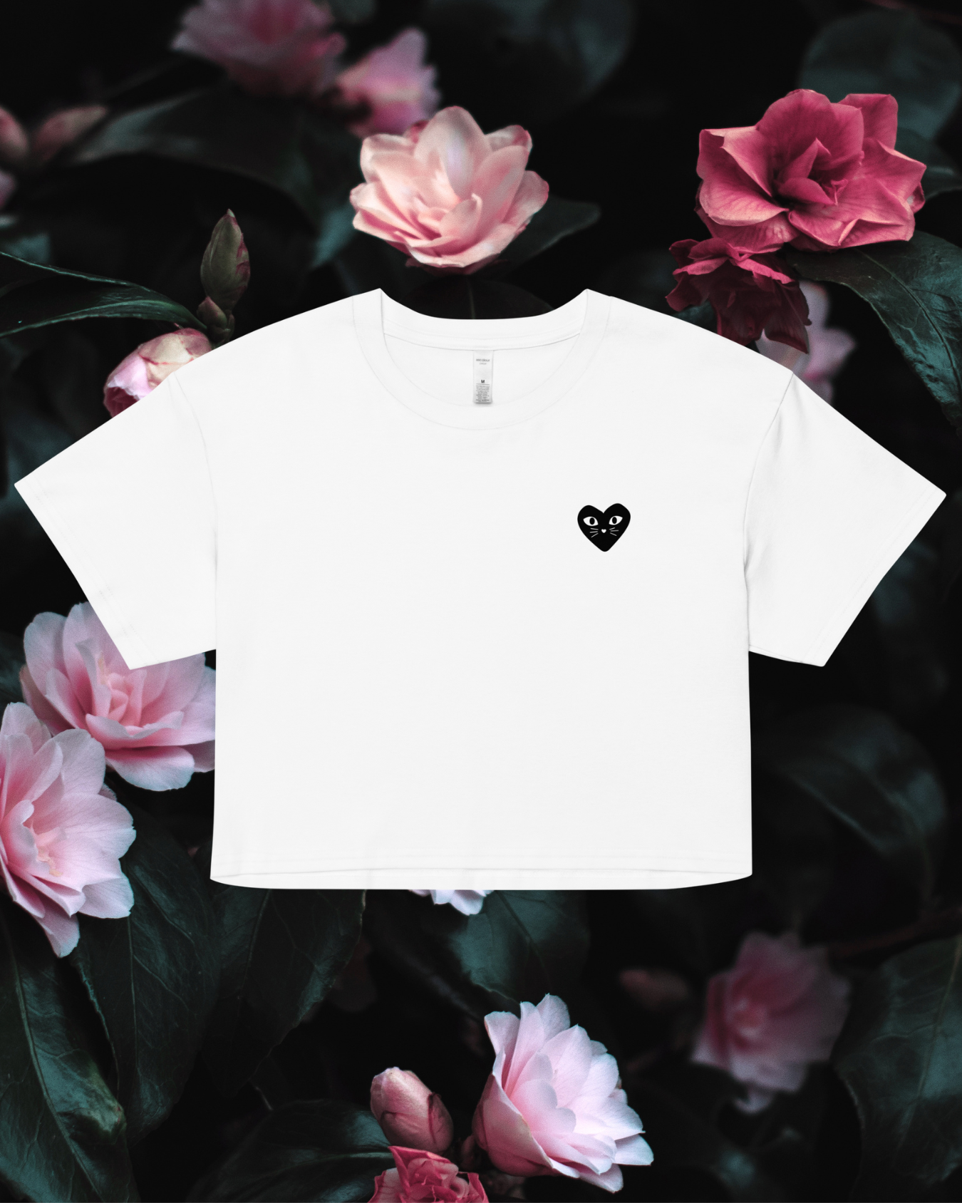Cropped white t-shirt with a black heart kitten design on a floral background