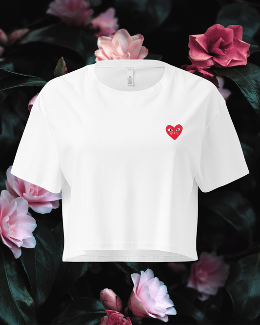 White t-shirt with a red heart kitten logo on a floral background