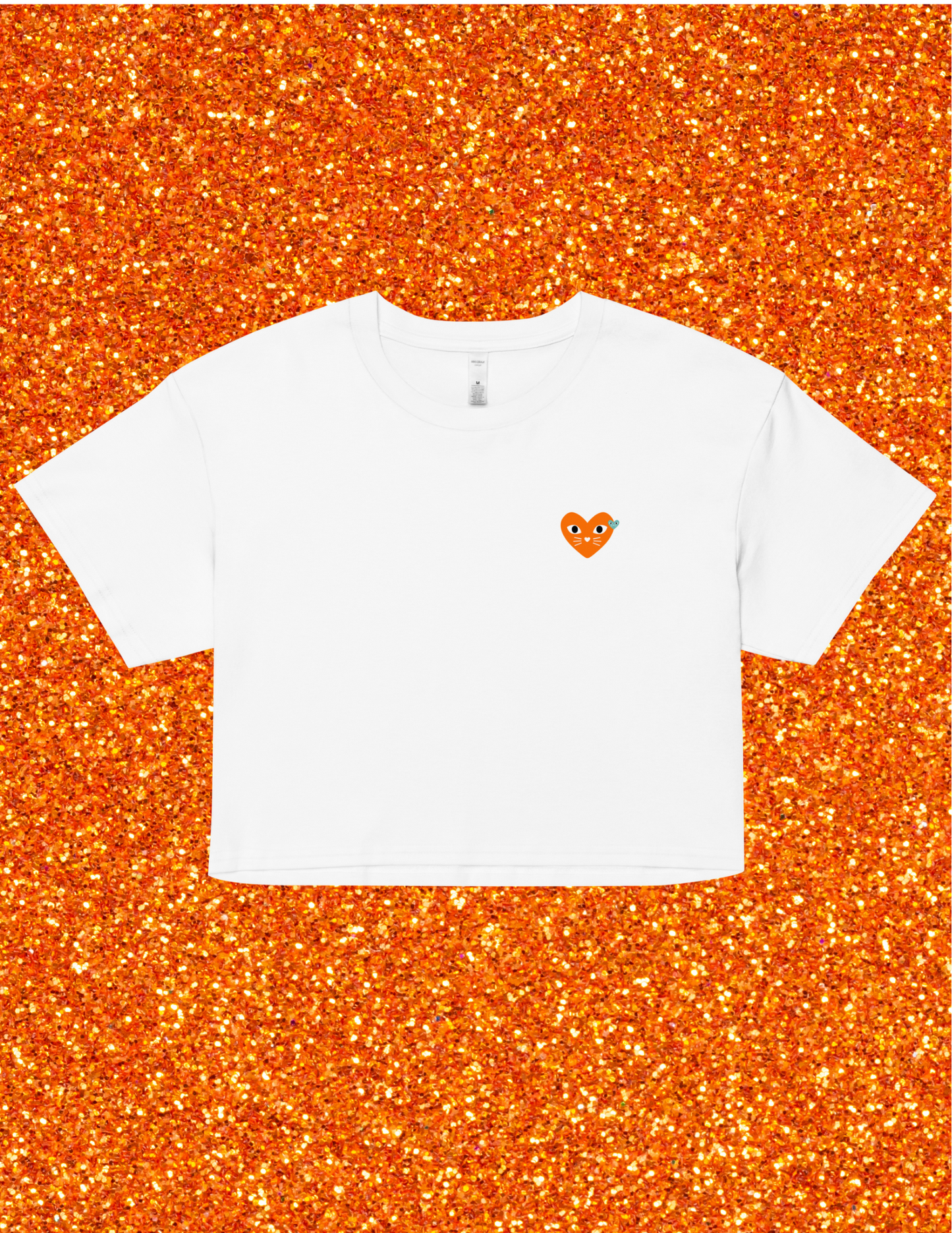 White t-shirt with a small orange logo on an orange glittery background
