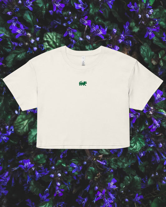 White t-shirt with a green logo on a floral background