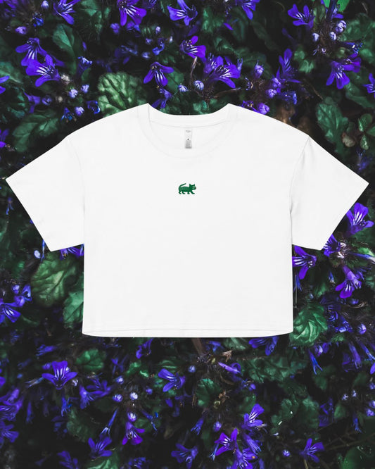 White t-shirt with a green logo on a floral background