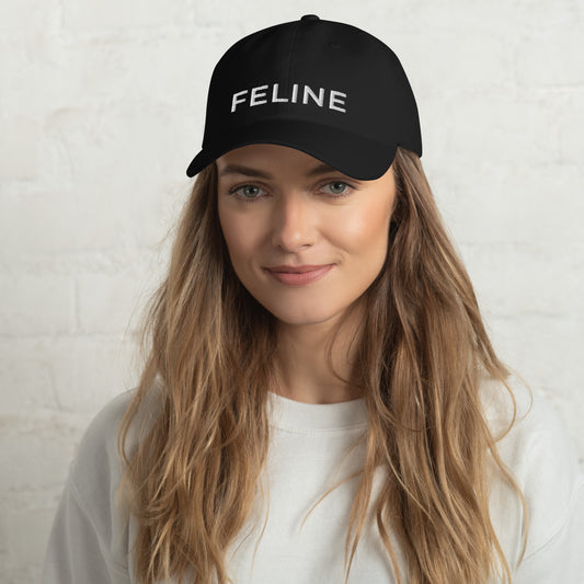 Person wearing a black cap with 'FELINE' text on a white background