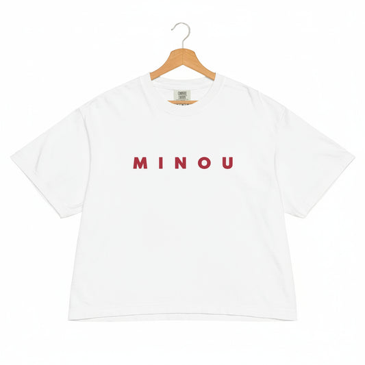 White t-shirt with 'MINOU' printed in red on a white background