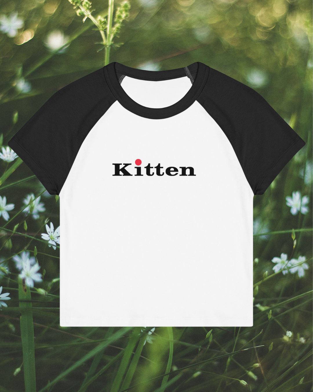Black and white baseball shirt with 'Kitten' text on a natural background