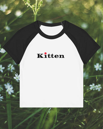 Black and white baseball shirt with 'Kitten' text on a natural background