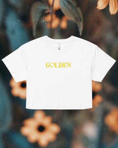 White t-shirt with 'GOLDEN' text on a floral background