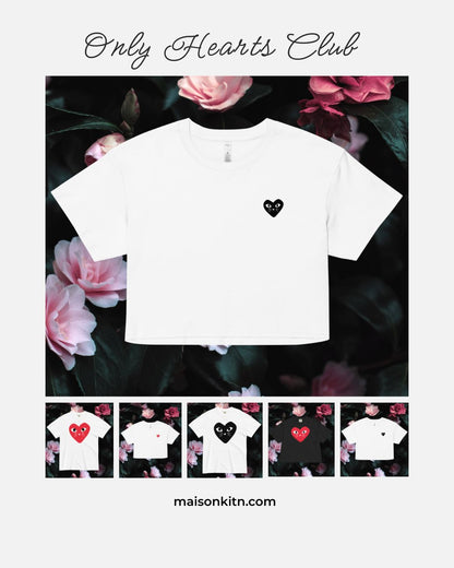 White t-shirt with a black heart design on a floral background, featuring 'Only Hearts Club' branding.