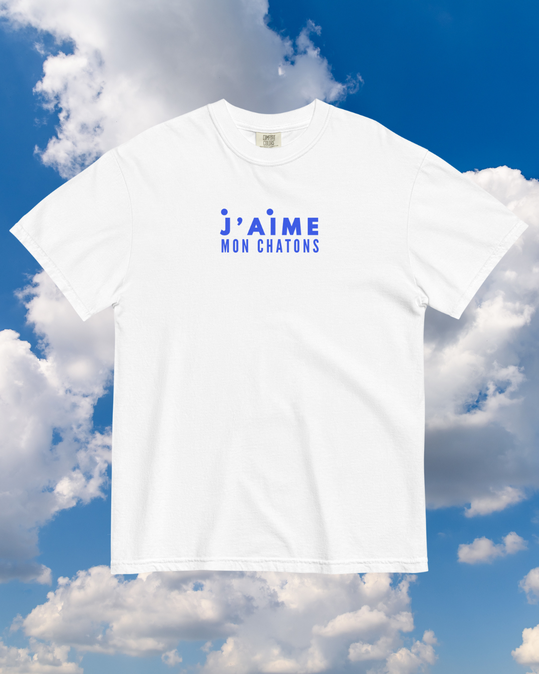 White t-shirt with blue text against a blue sky with clouds