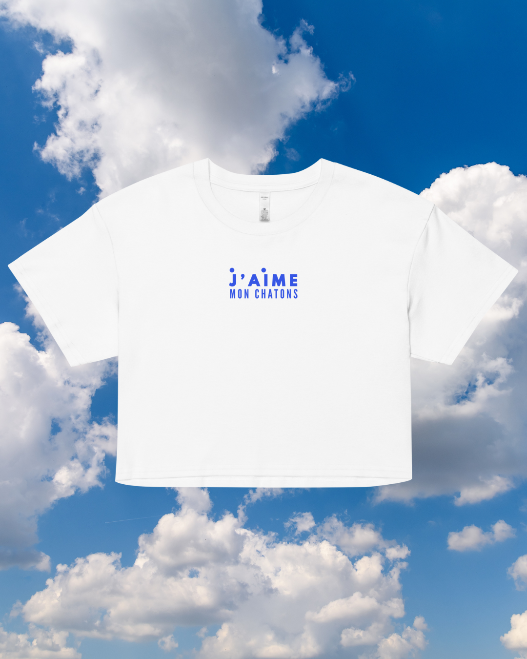 White t-shirt with blue text against a blue sky with clouds