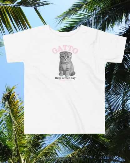 White t-shirt with a cat graphic and text 'Gatto Have a nice day!' against a palm tree background