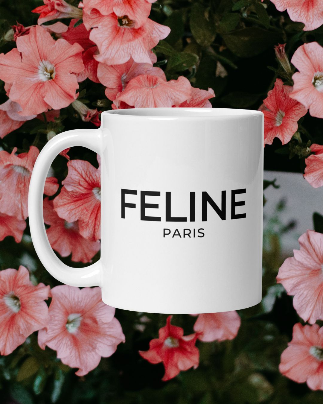 White mug with 'FELINE PARIS' text on a floral background