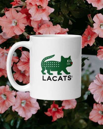 White mug with green and black logo on a background of pink flowers
