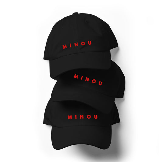 Three black baseball caps with 'MINOU' printed in red on a white background