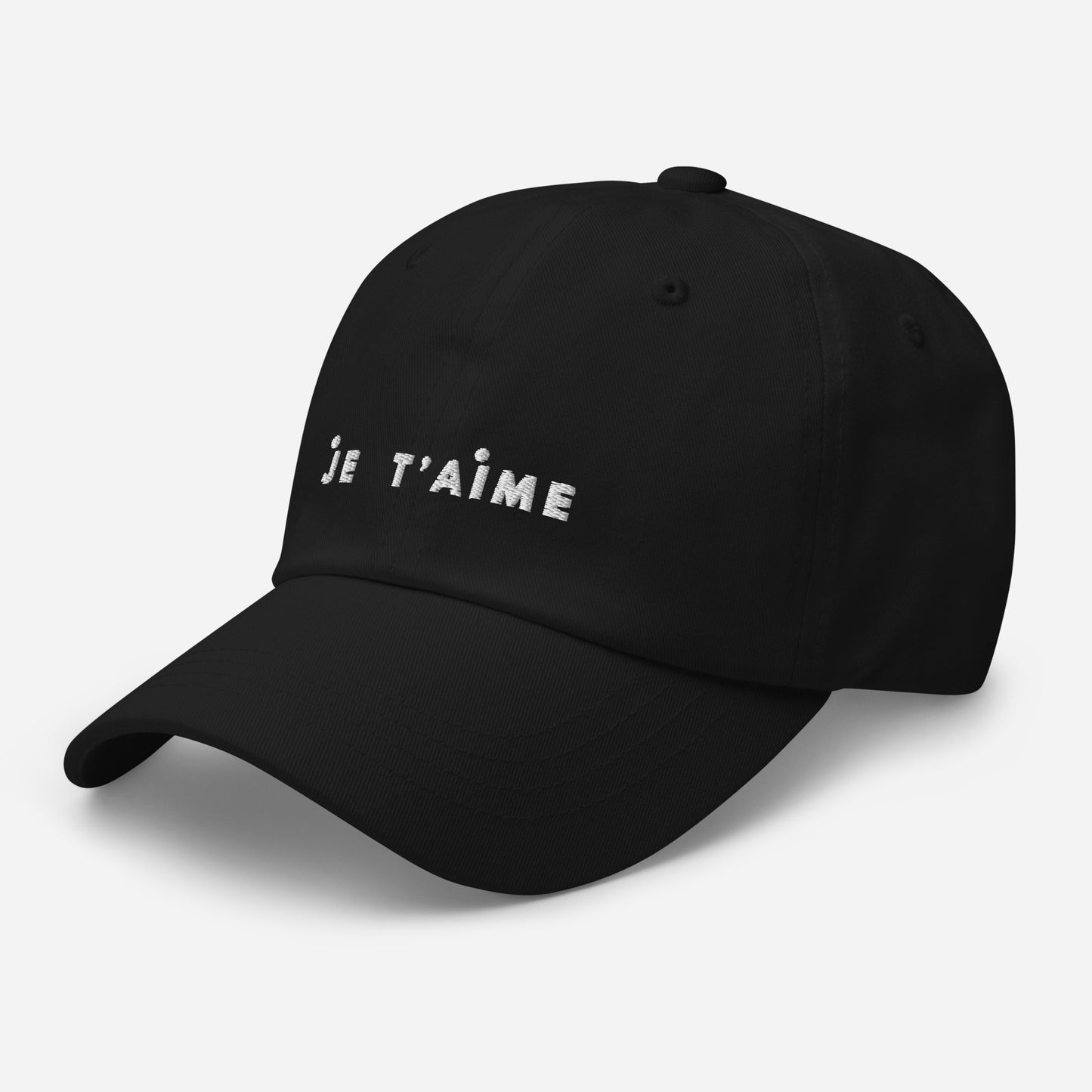 Black cap with 'Je T'aime' text on a light gray background