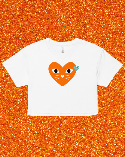 White t-shirt with a heart-shaped cat design on an orange glittery background