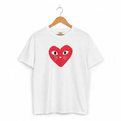 White t-shirt with a red heart design featuring eyes and a mouth on a white background