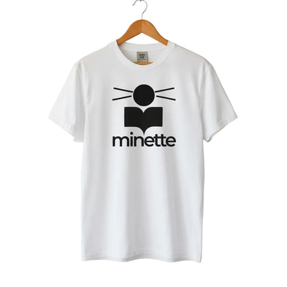White t-shirt with black logo and 'minette' text on a white background
