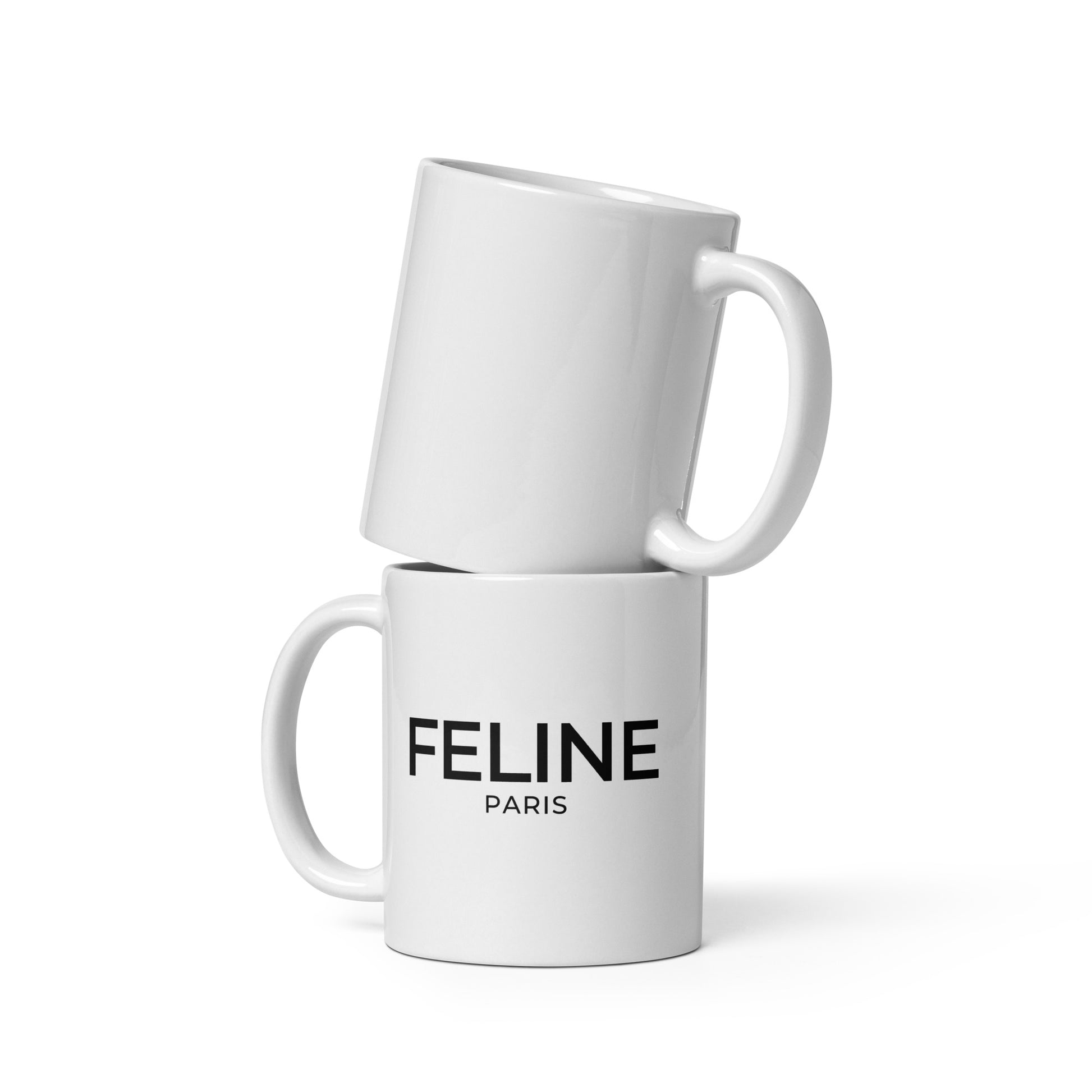 Two white mugs stacked on a white background with 'Feline Paris' branding.