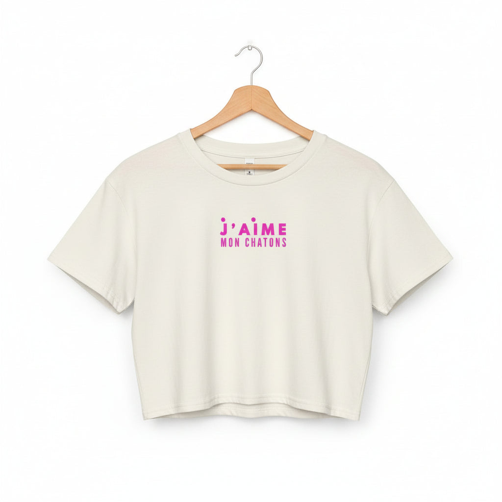 White crop top with pink text on a white background