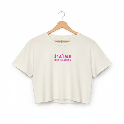 White crop top with pink text on a white background