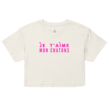 White crop top with pink text on a white background