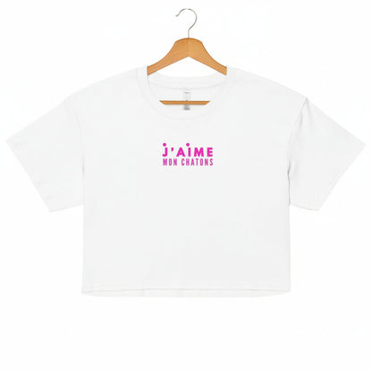 White t-shirt with pink text on a white background