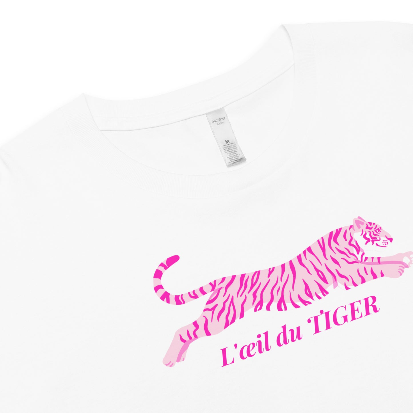 White t-shirt with pink tiger design and 'L'oeil du Tiger' text on a white background